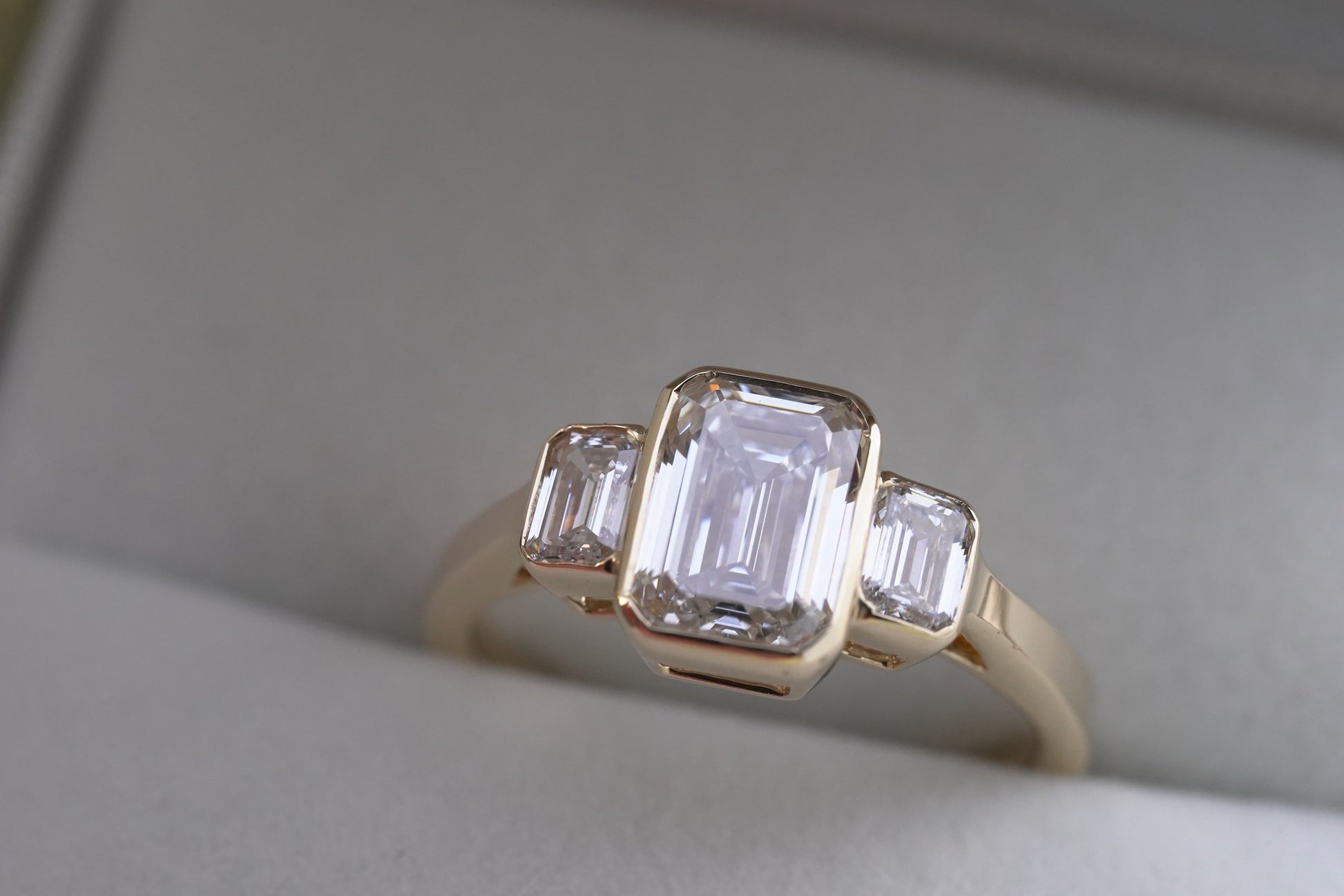 Bezel Set Emerald Trilogy Engagement Ring - Main Image